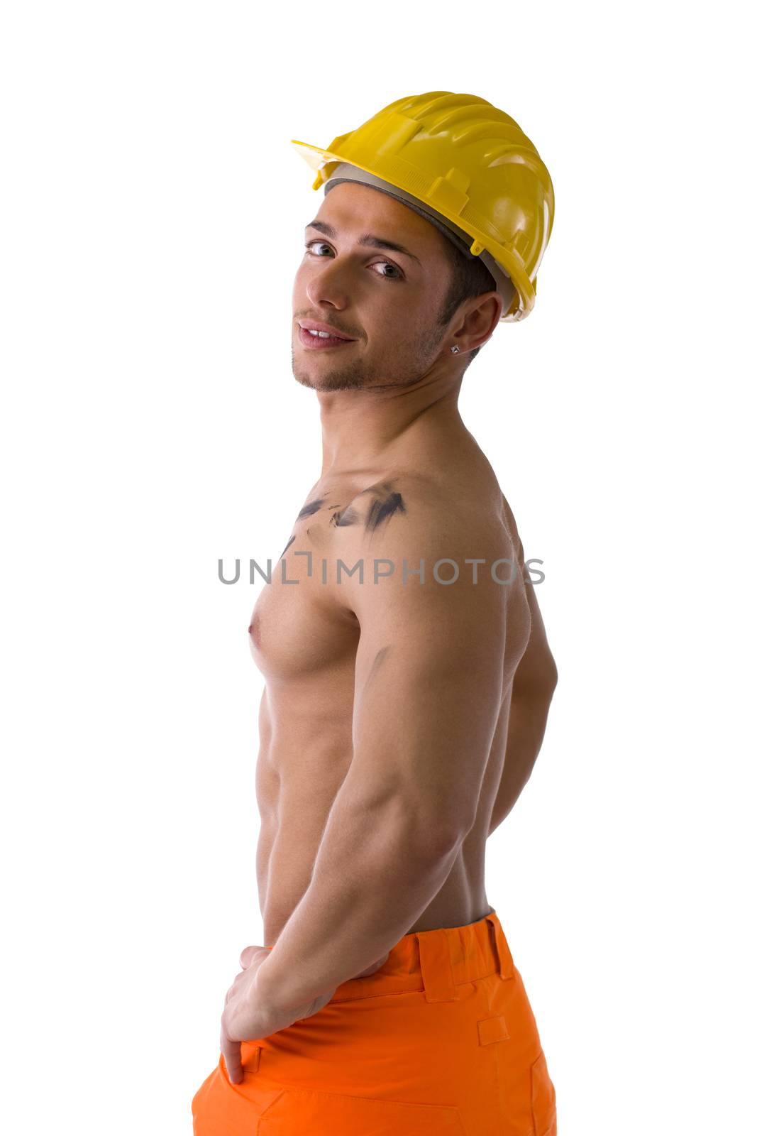 Muscular young construction worker shirtless with hardhat, isolated on white background, looking at camera