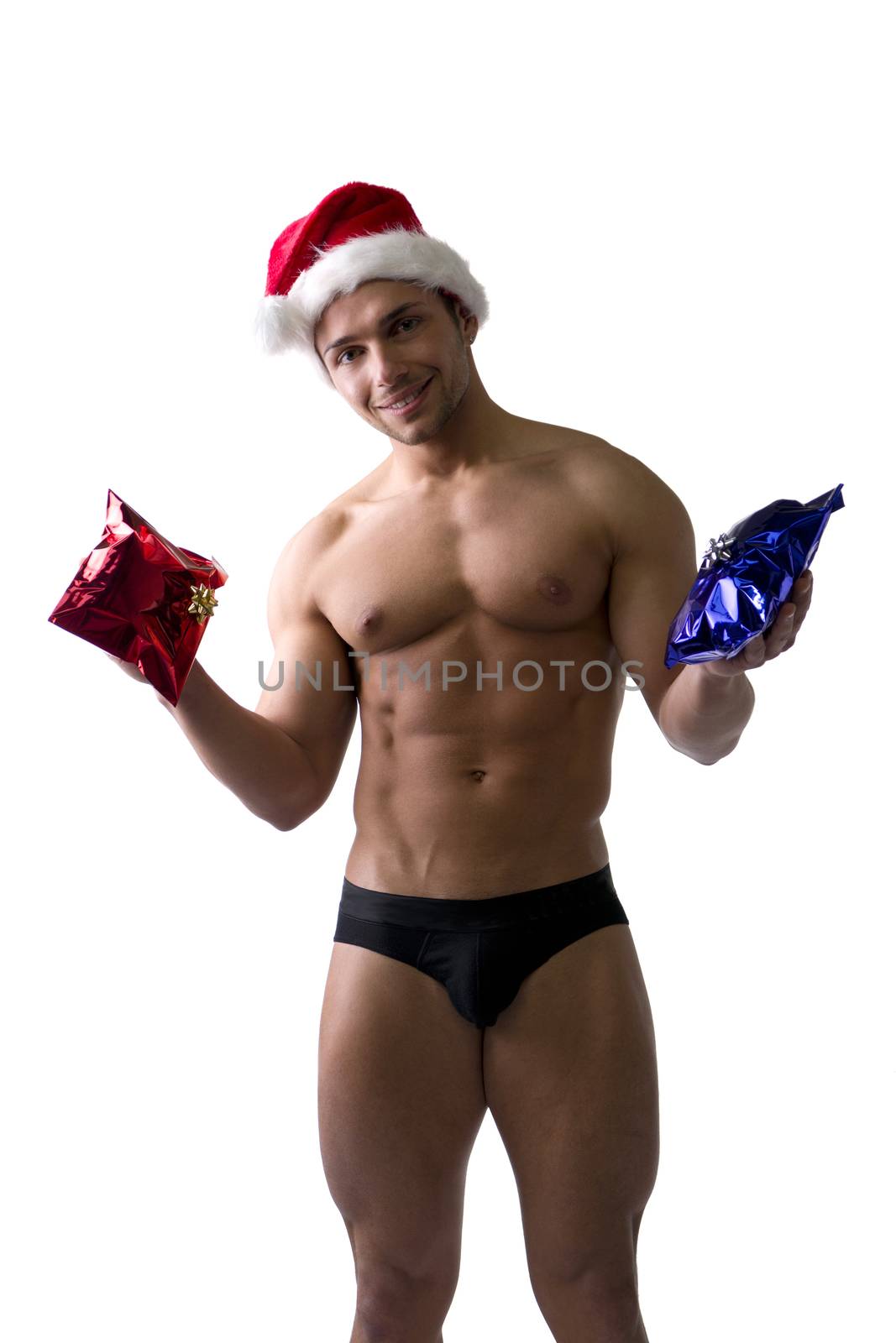 Christmas season: muscular bodybuilder shirtless wearing Santa Claus red hat, isolated on white