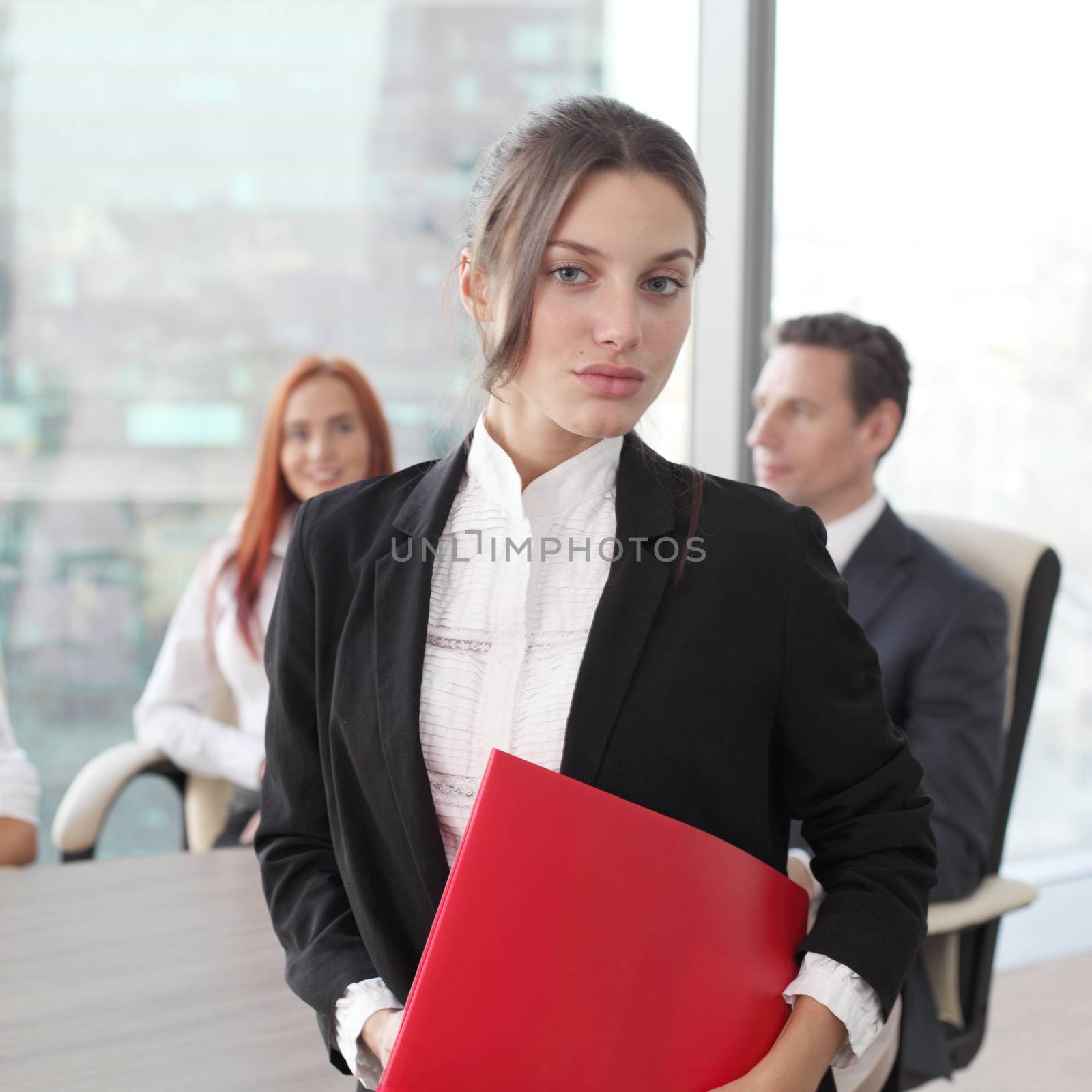 Group portrait of a professional business woman and team looking confidently at camera