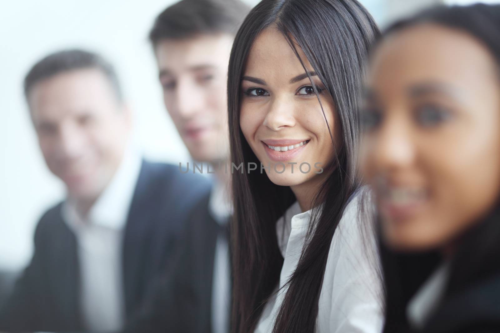 Business people sitting in a row and working, focus on pretty woman