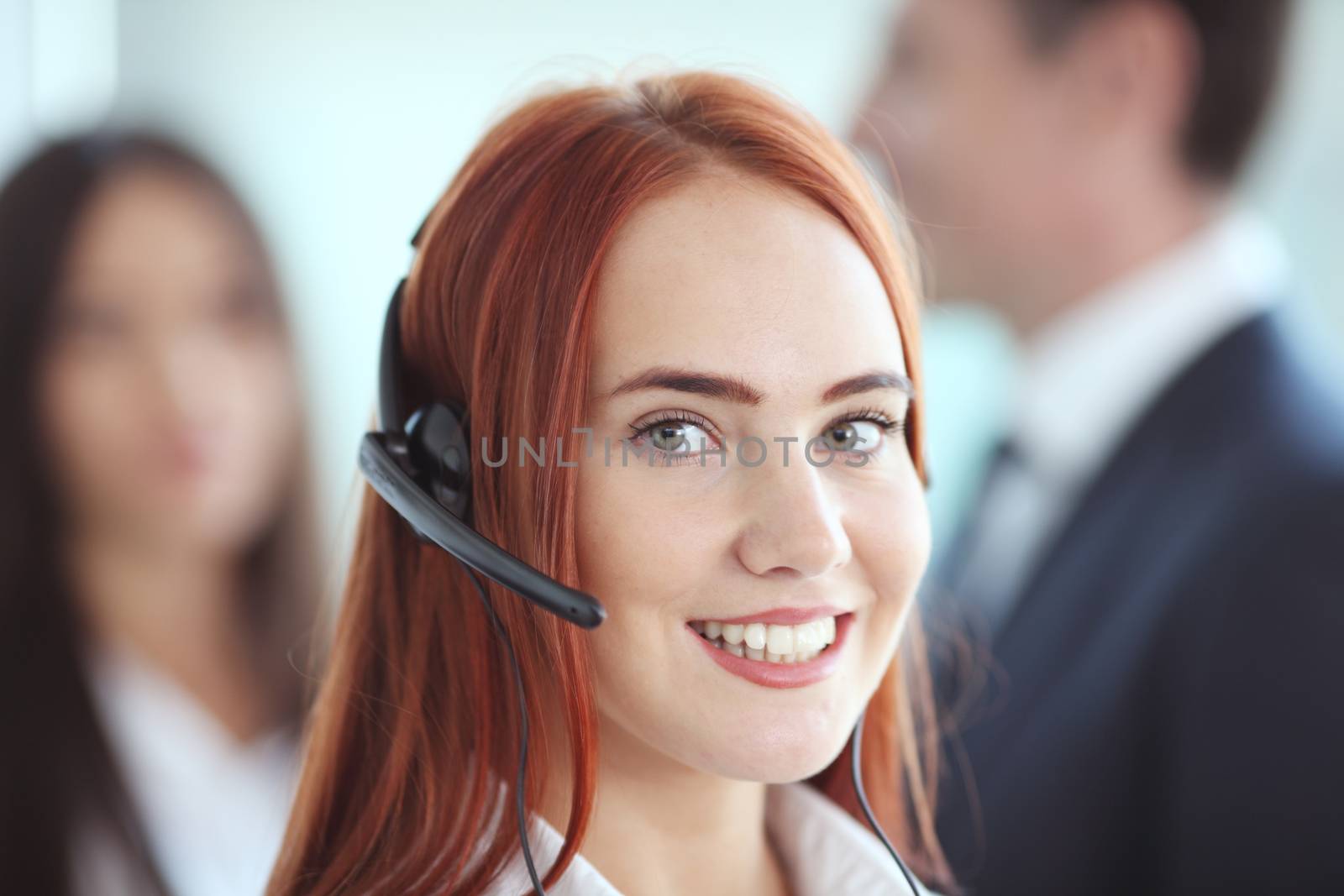Portrait of a smiling creative businesswoman with earpiece in office