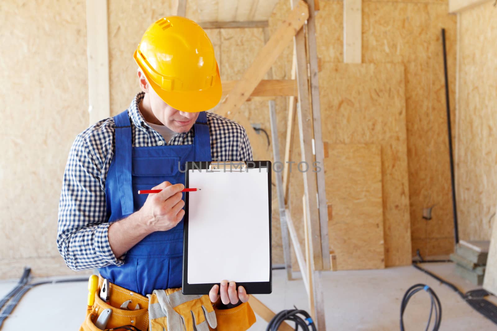 Worker pointing at a clipboard with blank paper, contract concept