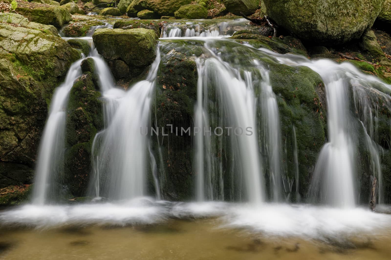 Beautiful Maly waterfall in super green spring forest surroundings, Czech Republic