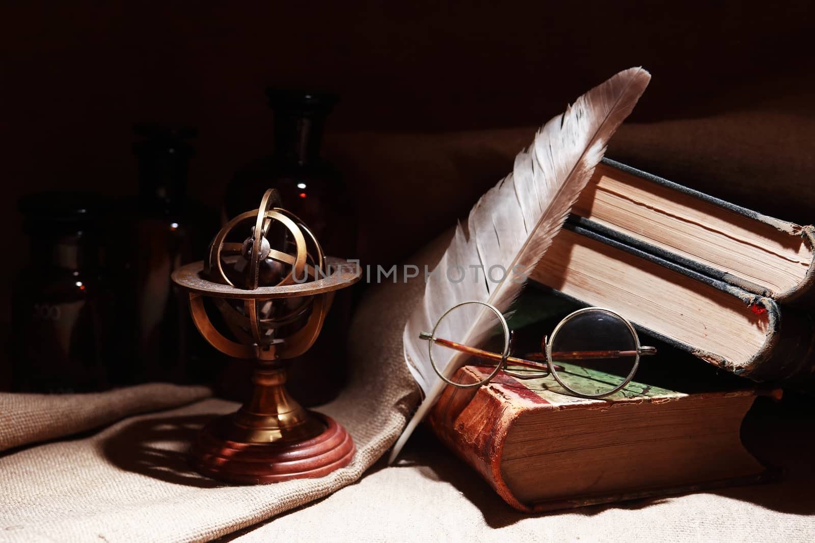 Vintage still life with old books and spectacles on canvas background