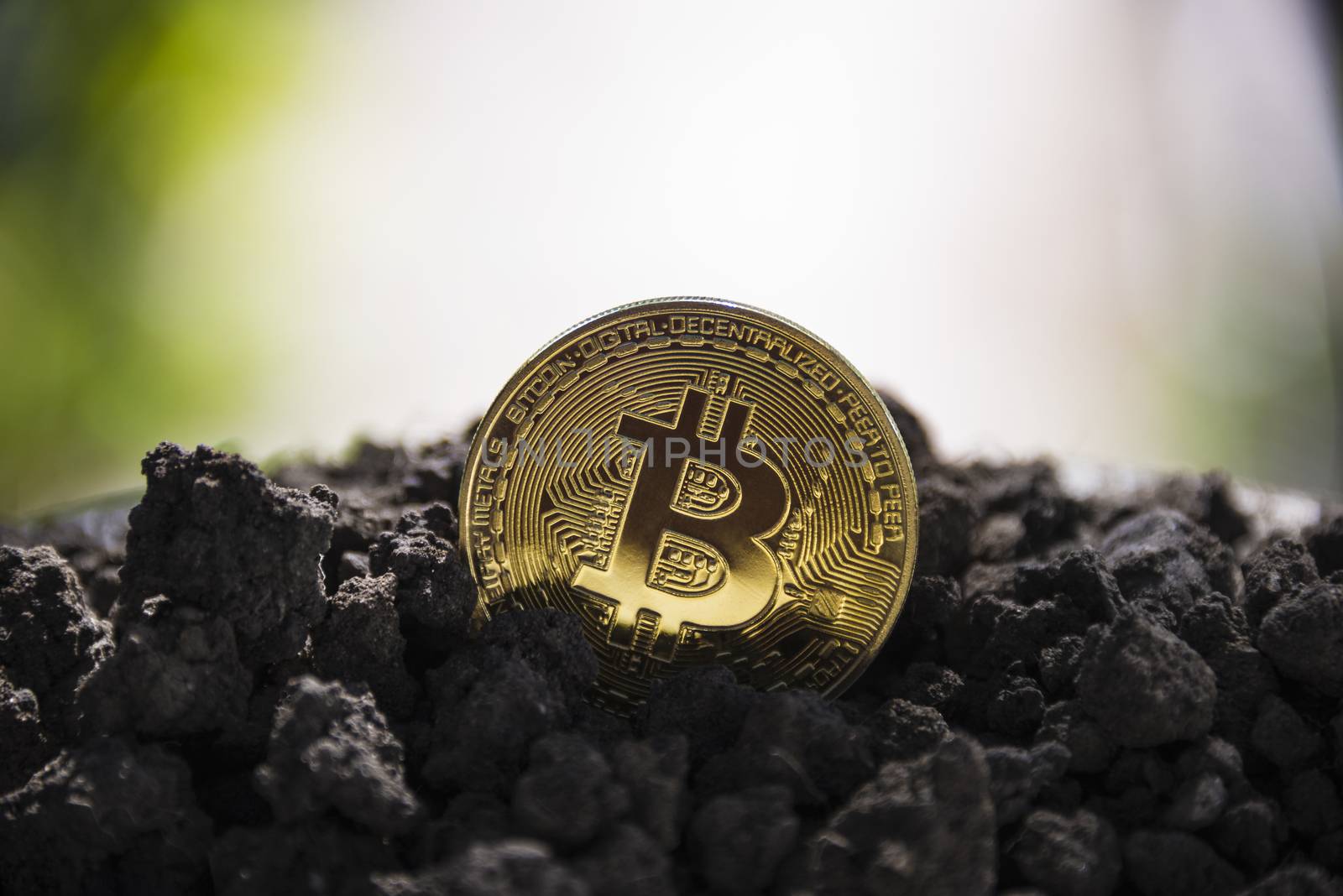 Golden Bitcoin coin on the background of the earth.