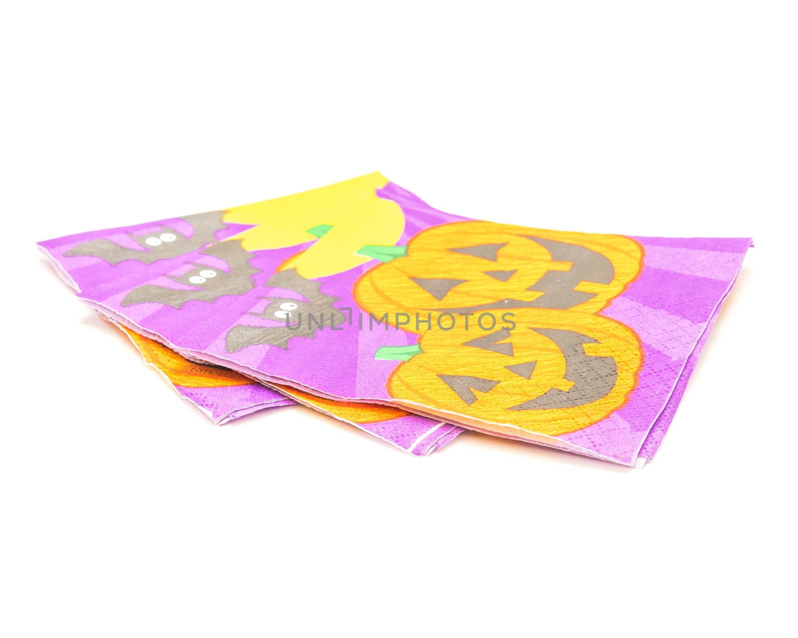 Three friendly Halloween napkins isolated on white background. Festive party tissues display pumpkins, bats, jack-o-lantern