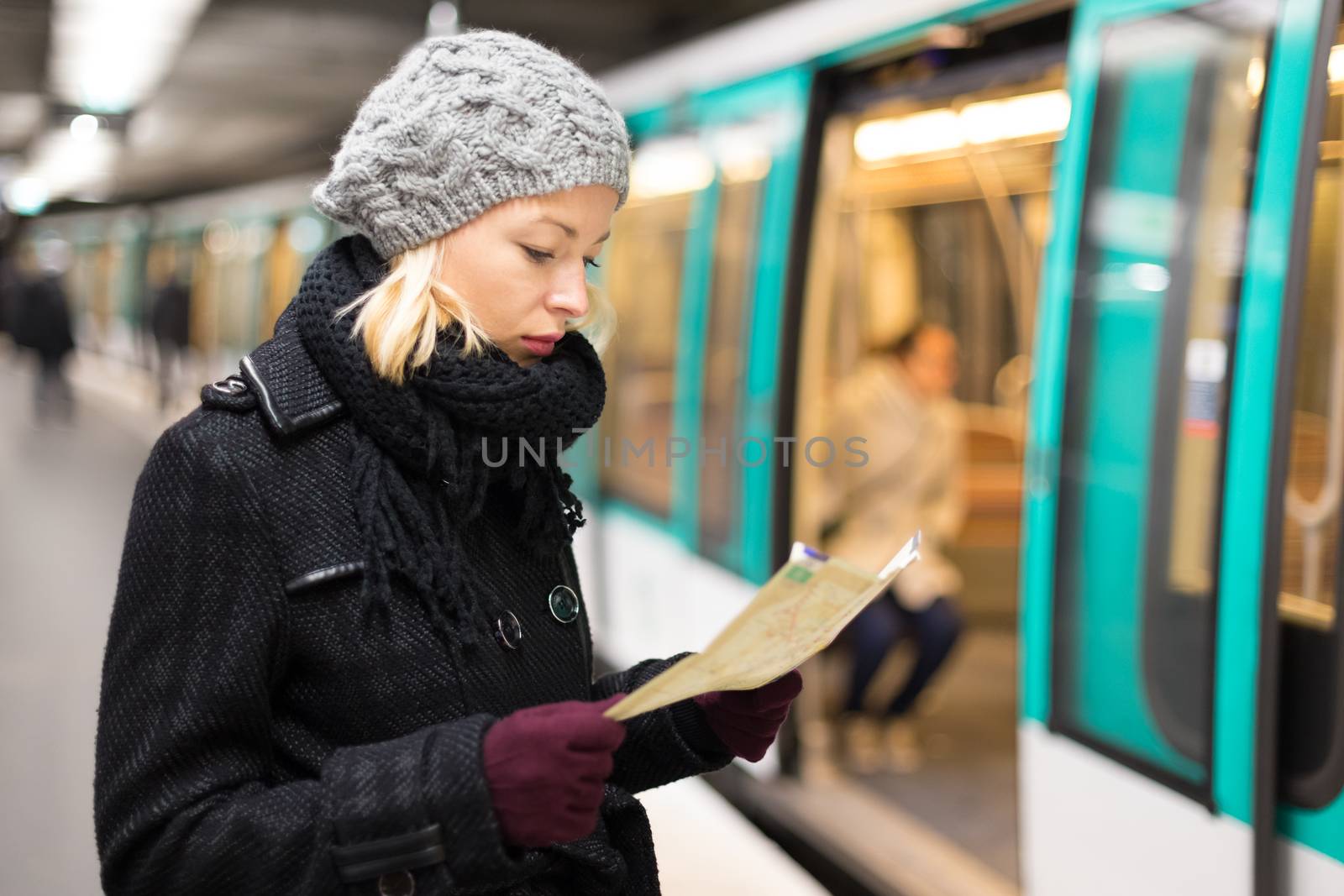 Lady waiting on subway station platform. by kasto