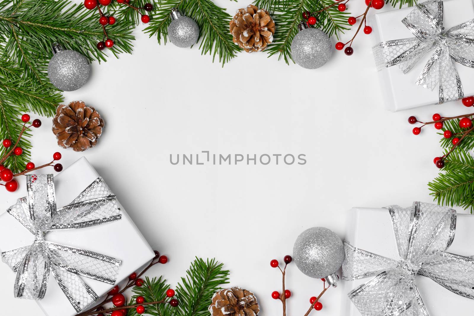 Christmas background with balls and decorations of holly berry, cones, gifts, balls on white