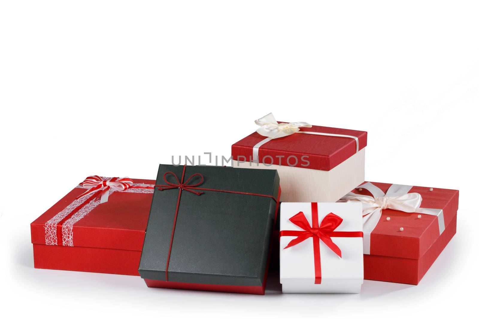 Boxes with gifts tied with ribbons and bows isolated on white background