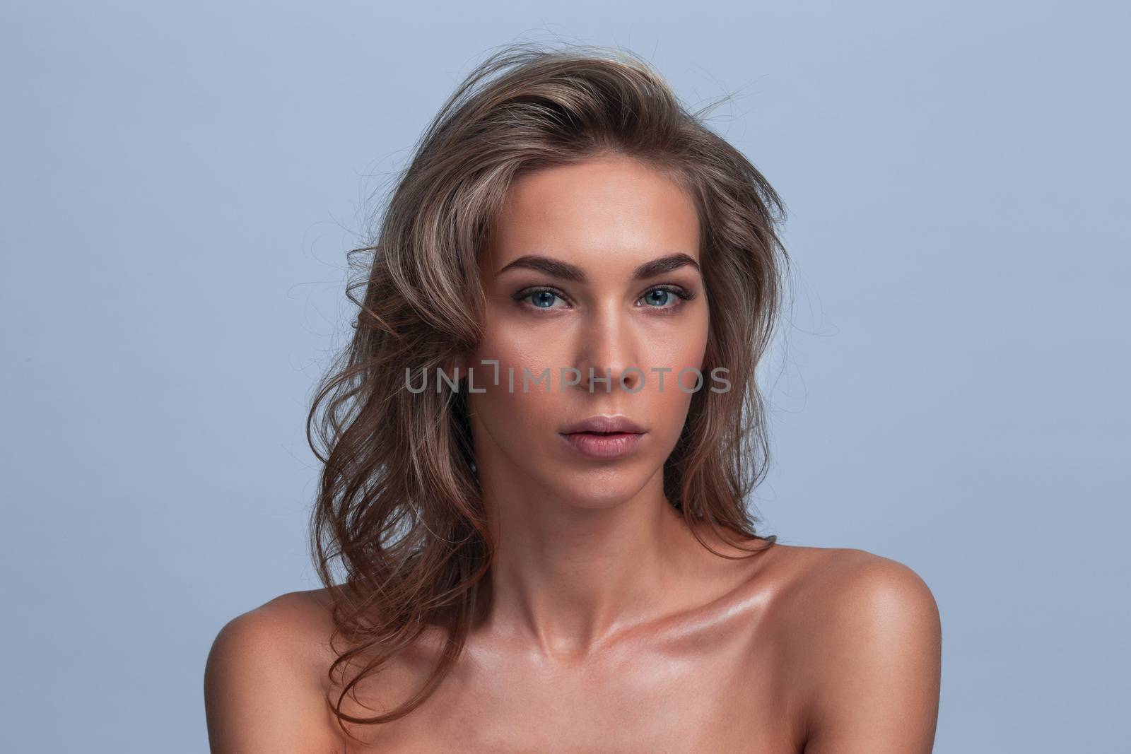 Portrait of a beautiful female model on gray background