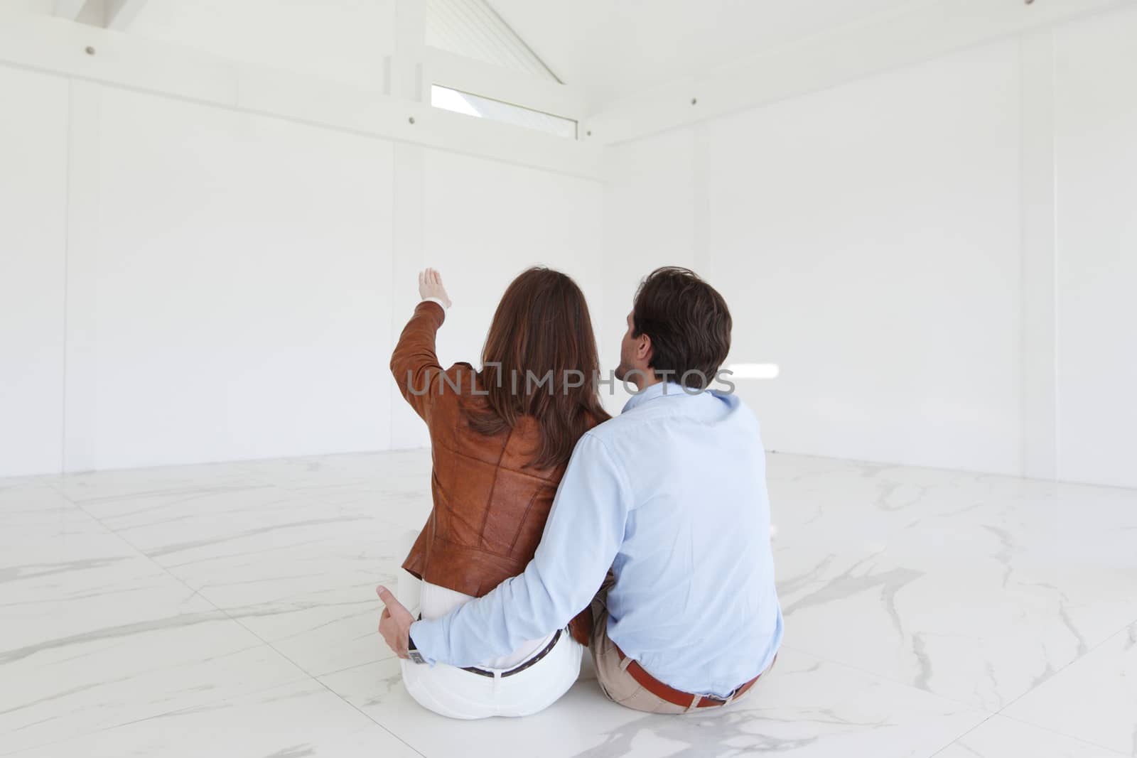 Couple at their new empty apartment by ALotOfPeople