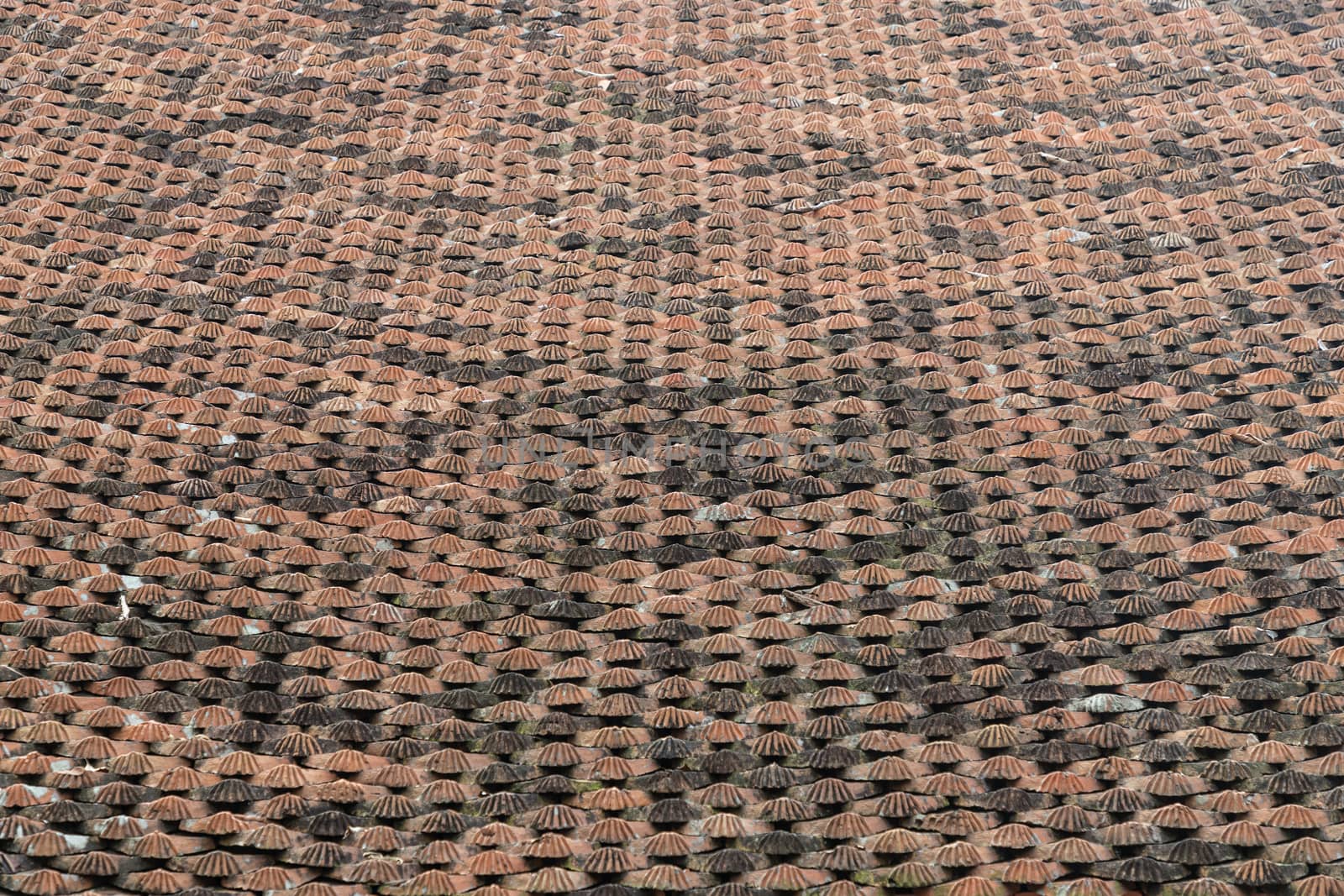 Temple roof tiles in Vietnam Some orange, some black, look aged