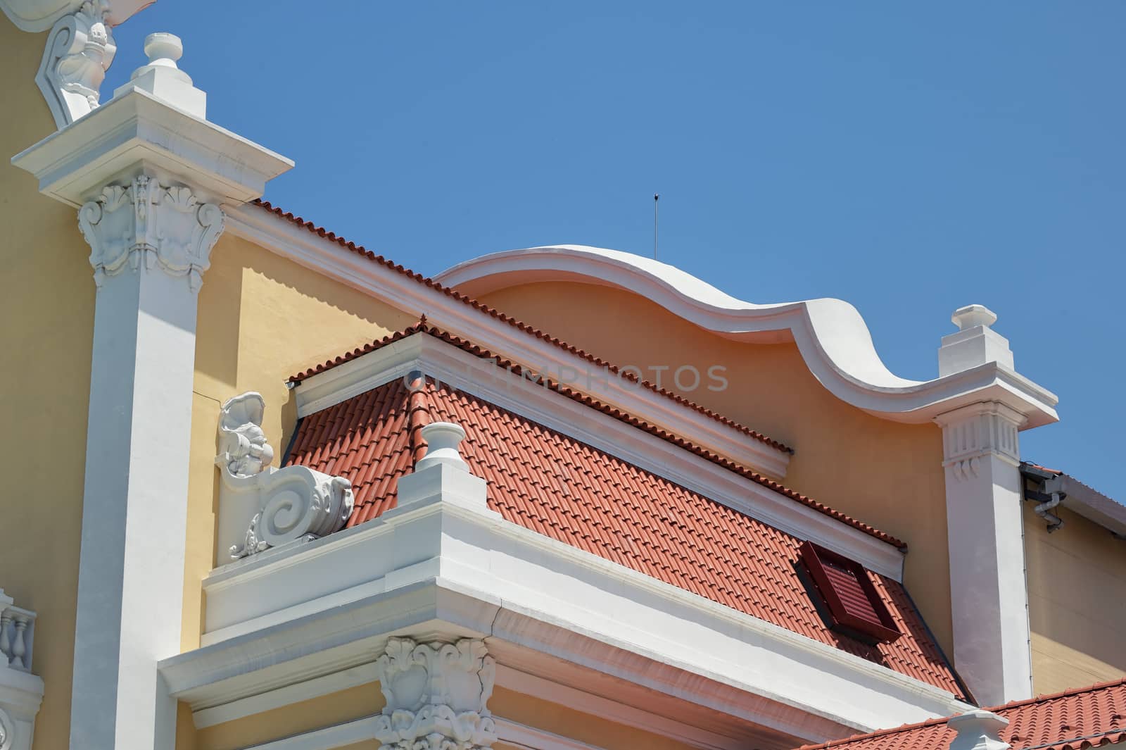 Roof tile pattern on classic house over blue sky