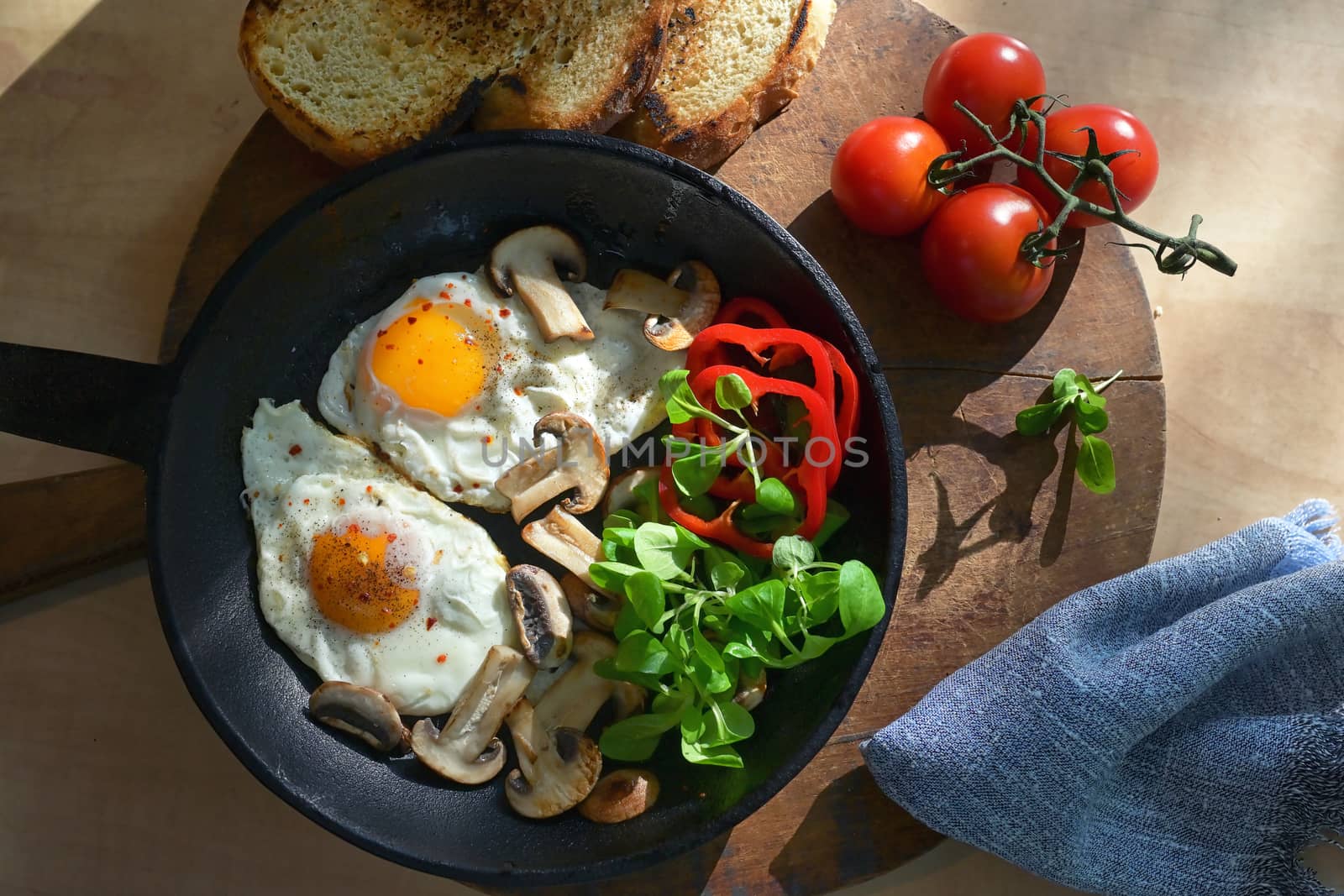Fried Eggs And Vegetables In A Frying Pan