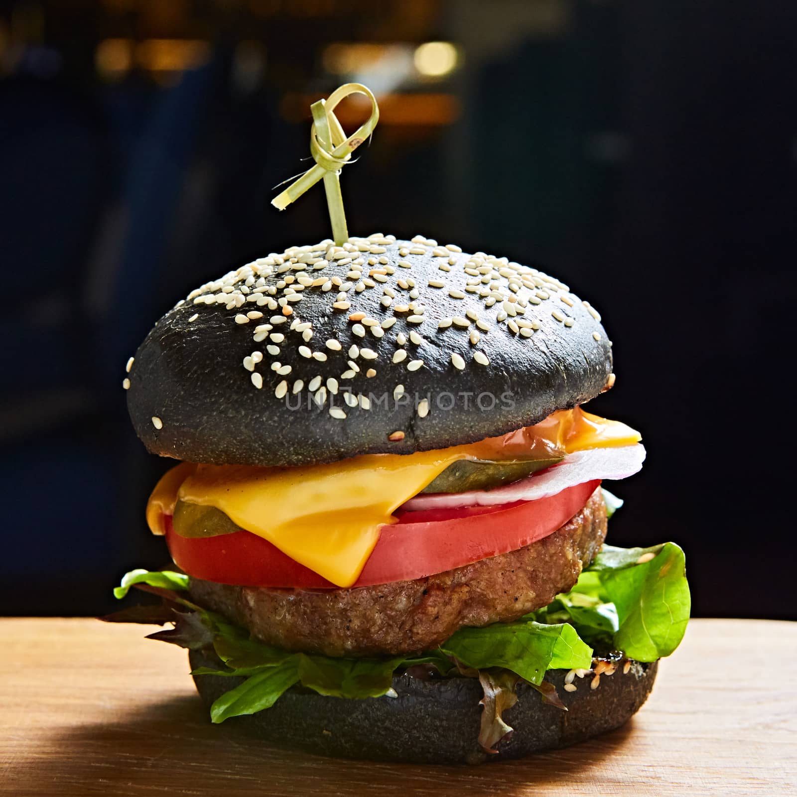 Japanese Black Burger with Cheese. Cheeseburger from Japan with black bun on dark background. by sarymsakov