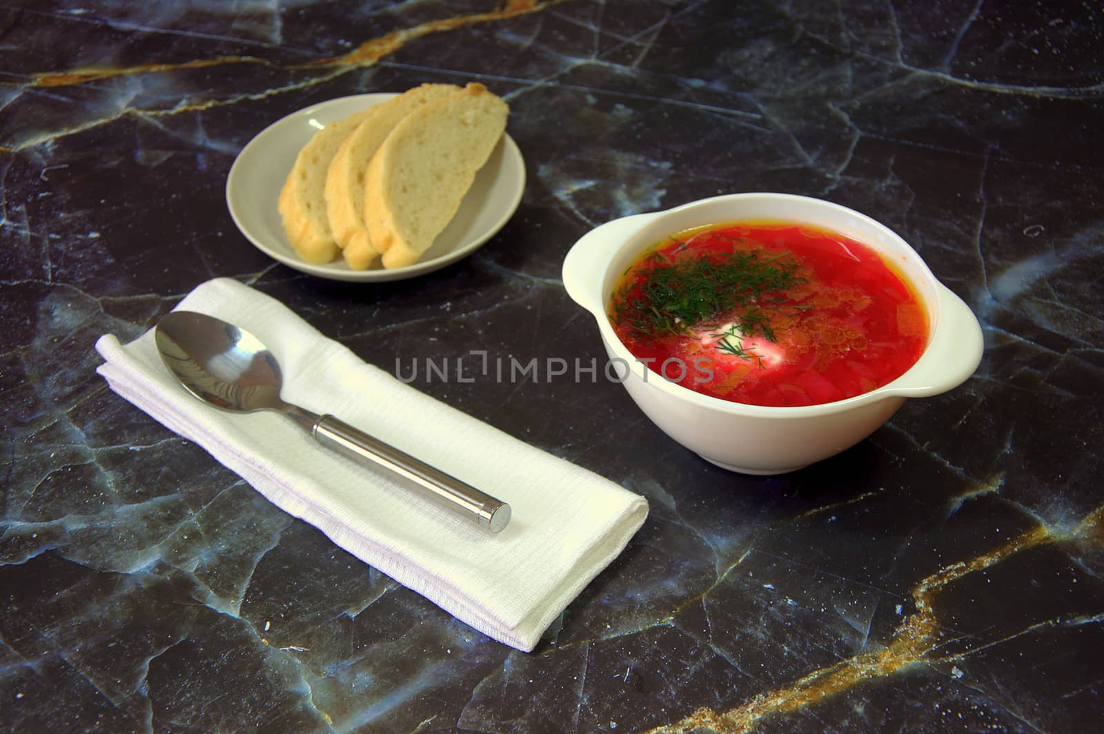 National Russian soup Red borsch with sour cream and herbs. Close-up.