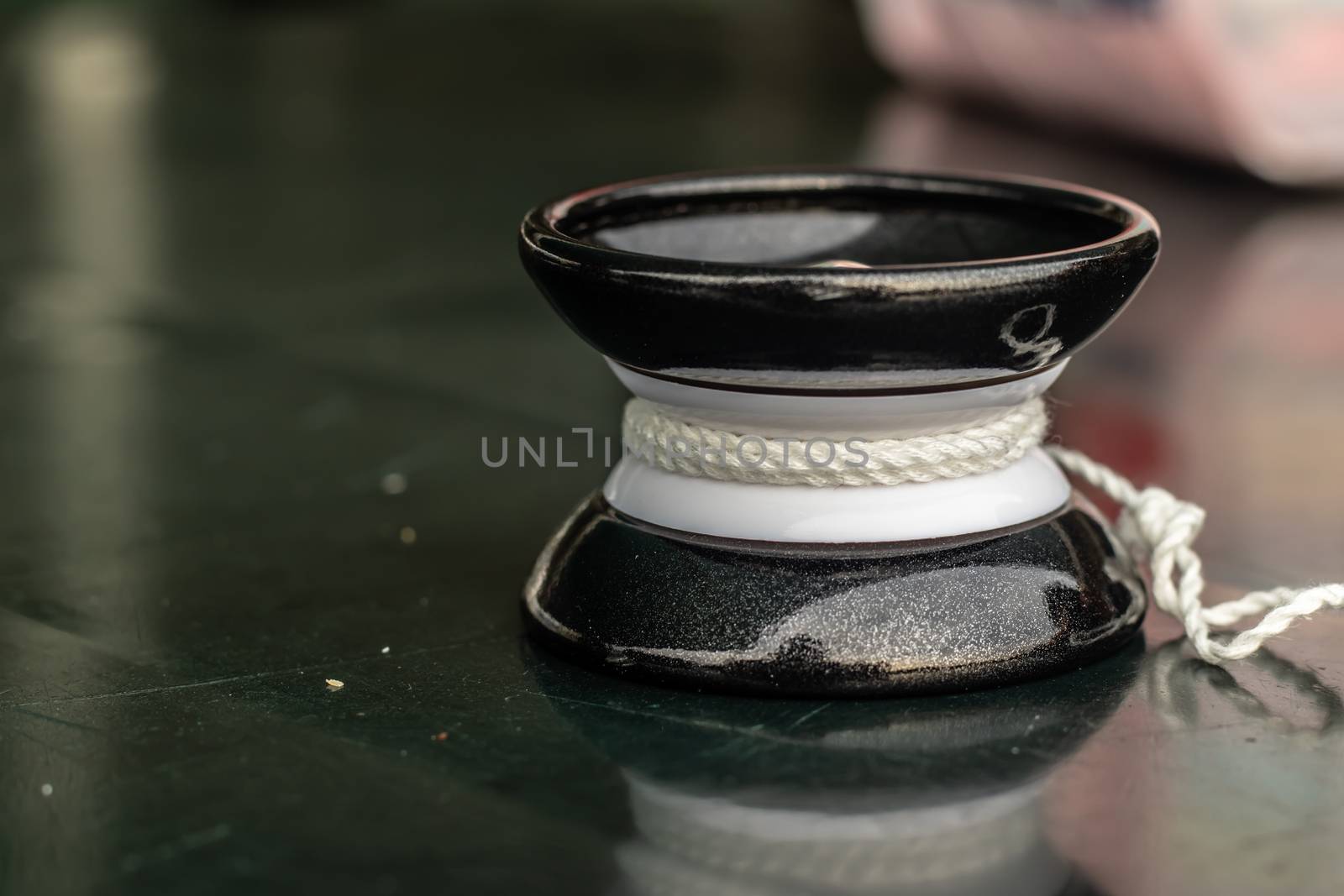 a closeup shoot from black yo-yo - there is green table under it and object isolated. photo has taken at izmir/turkey.