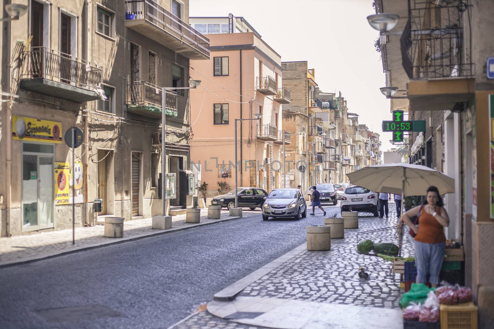 View of a street in the village of Gela with its daytime life in the south of Sicily in Italy.