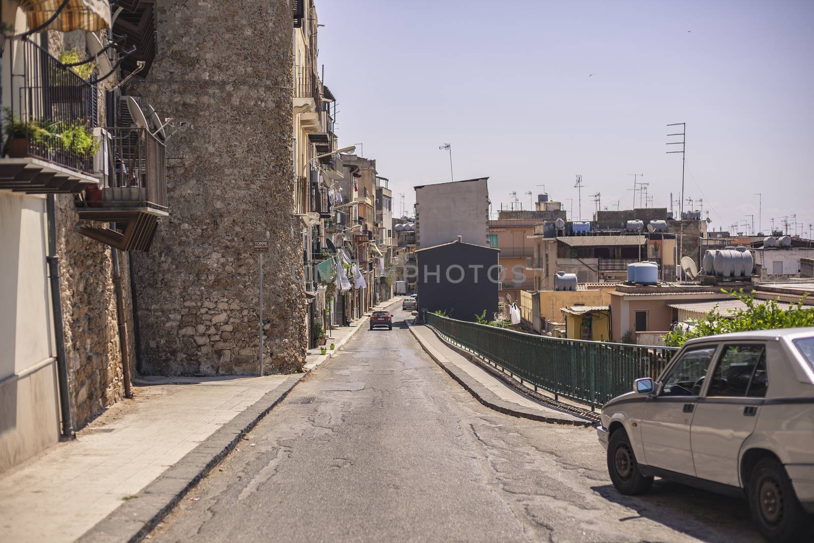 View of a street in the village of Gela with its daytime life in the south of Sicily in Italy.
