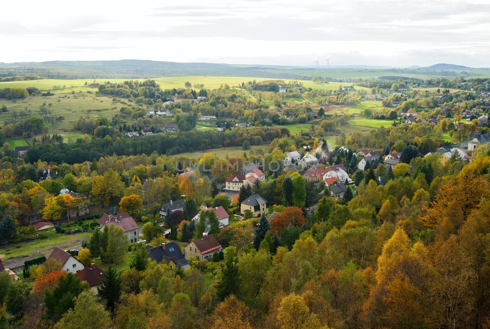 Autumn colorful landscape with forests, hills, sun and sky