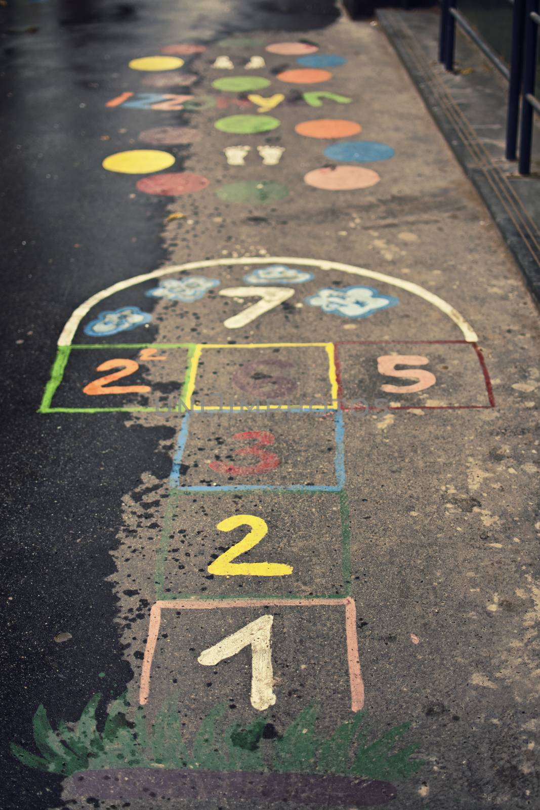 Children's hopscotch game with squares and numbers in different colors on the street.