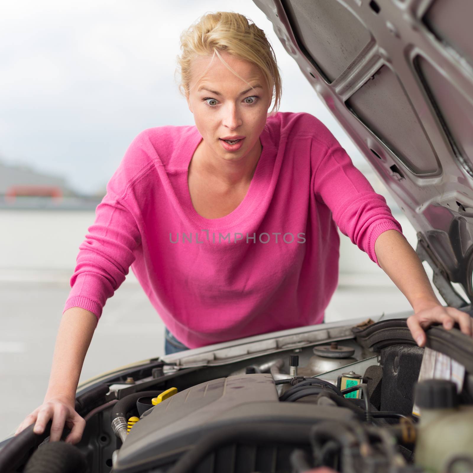 Stressed Young Woman with Car Defect. by kasto