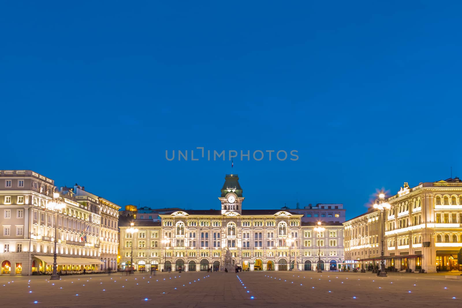 The City Hall or Palazzo del Municipio is the dominating building on Trieste's main square Piazza dell Unita d Italia. Trieste Italy Europe. Illuminated city square shot at dusk.