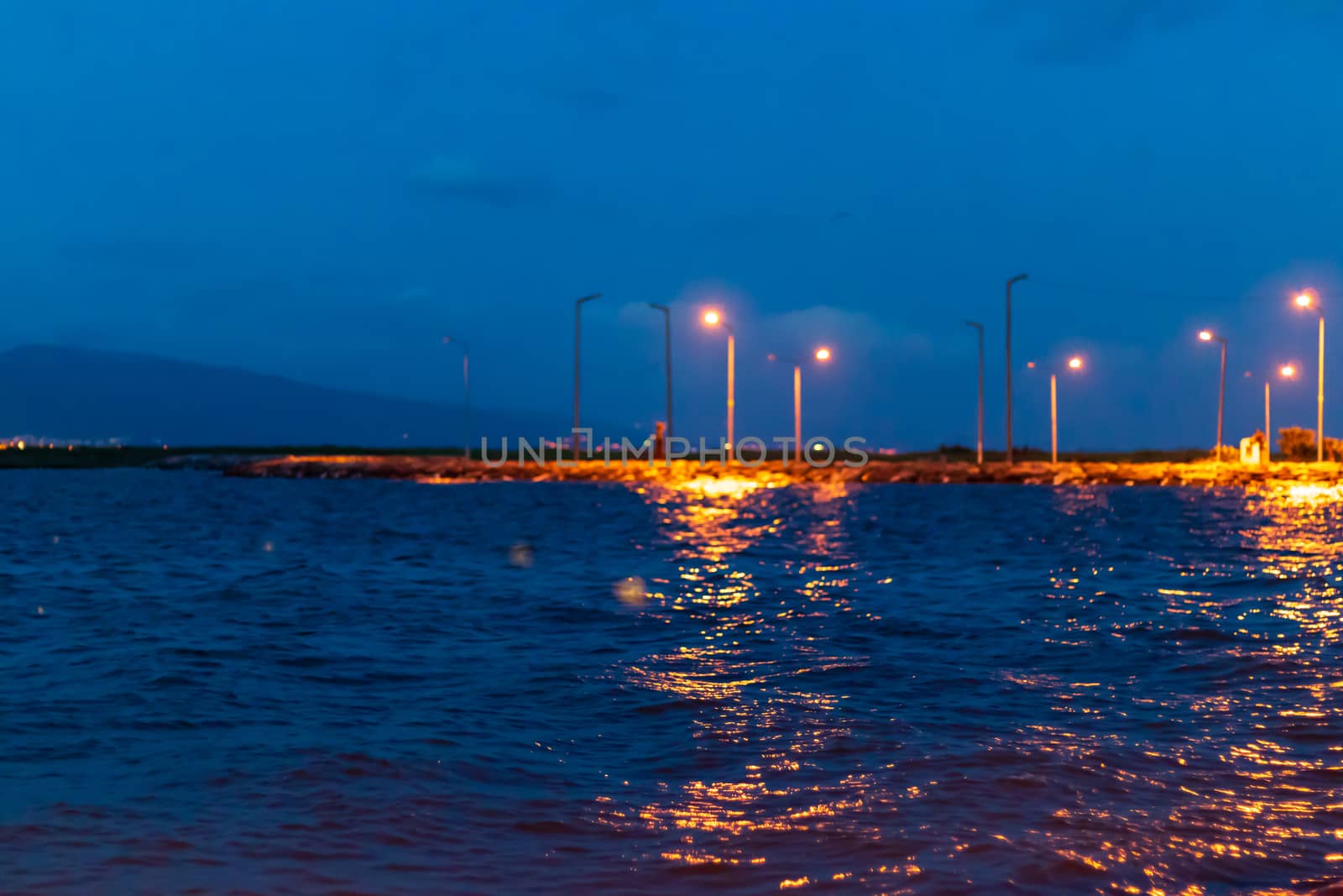 nice looking blue color dominated nightscape shoot from city lights and sea. photo has taken from izmir turkey.