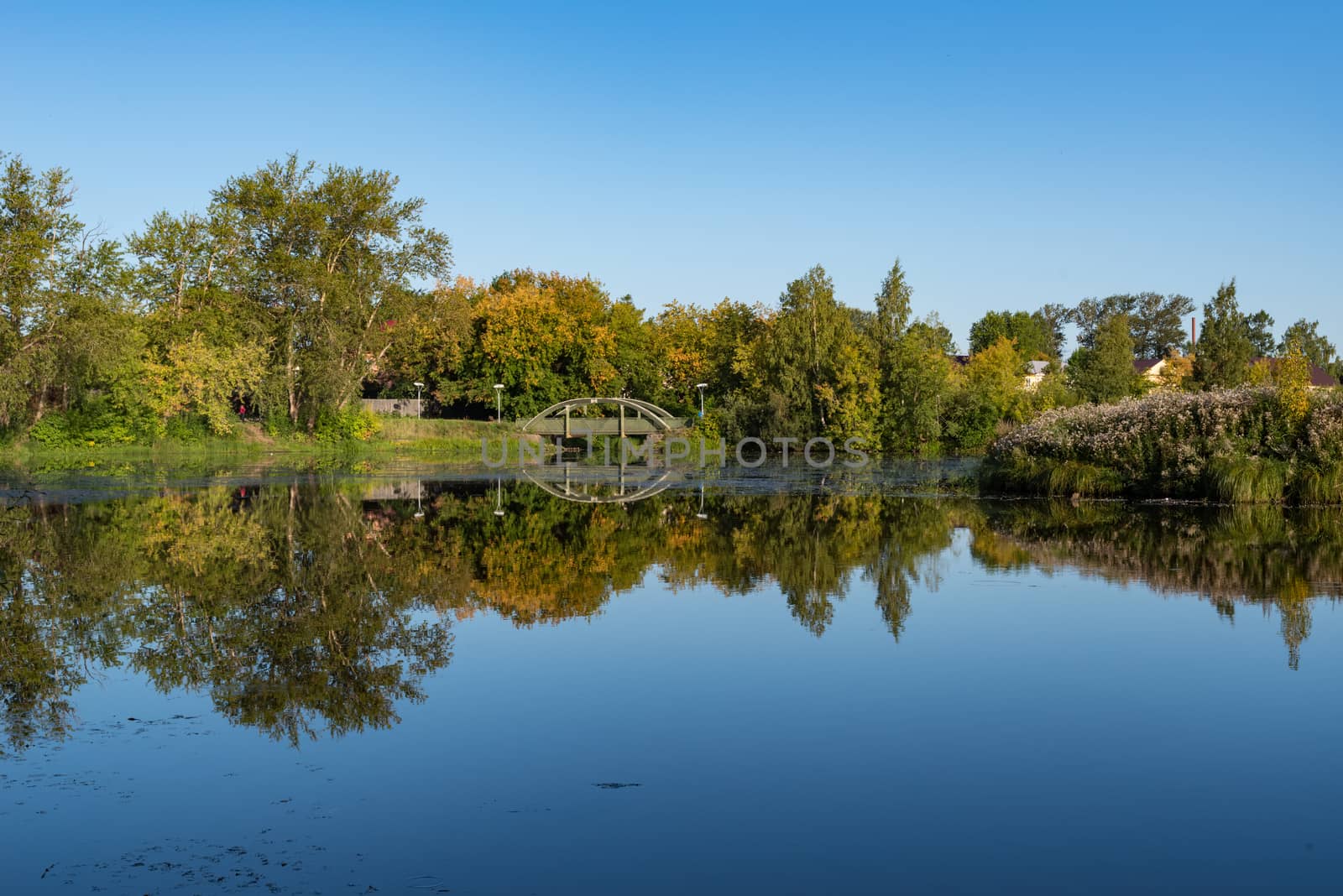 Zakharyevsky park, a bridge across the Tabora pond, next to Tikhvin Assumption (Bogorodichny Uspensky)  Monastery. Leningrad region. Russia