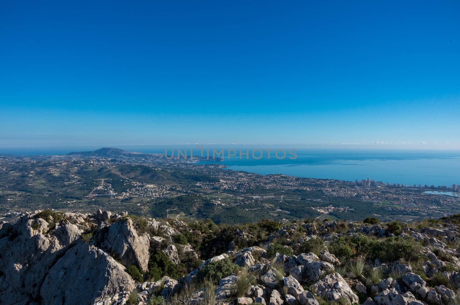 Panoramic view to Mediterranean sea and Calp area from cliffs on mountain range Serra d'Oltà, Spain