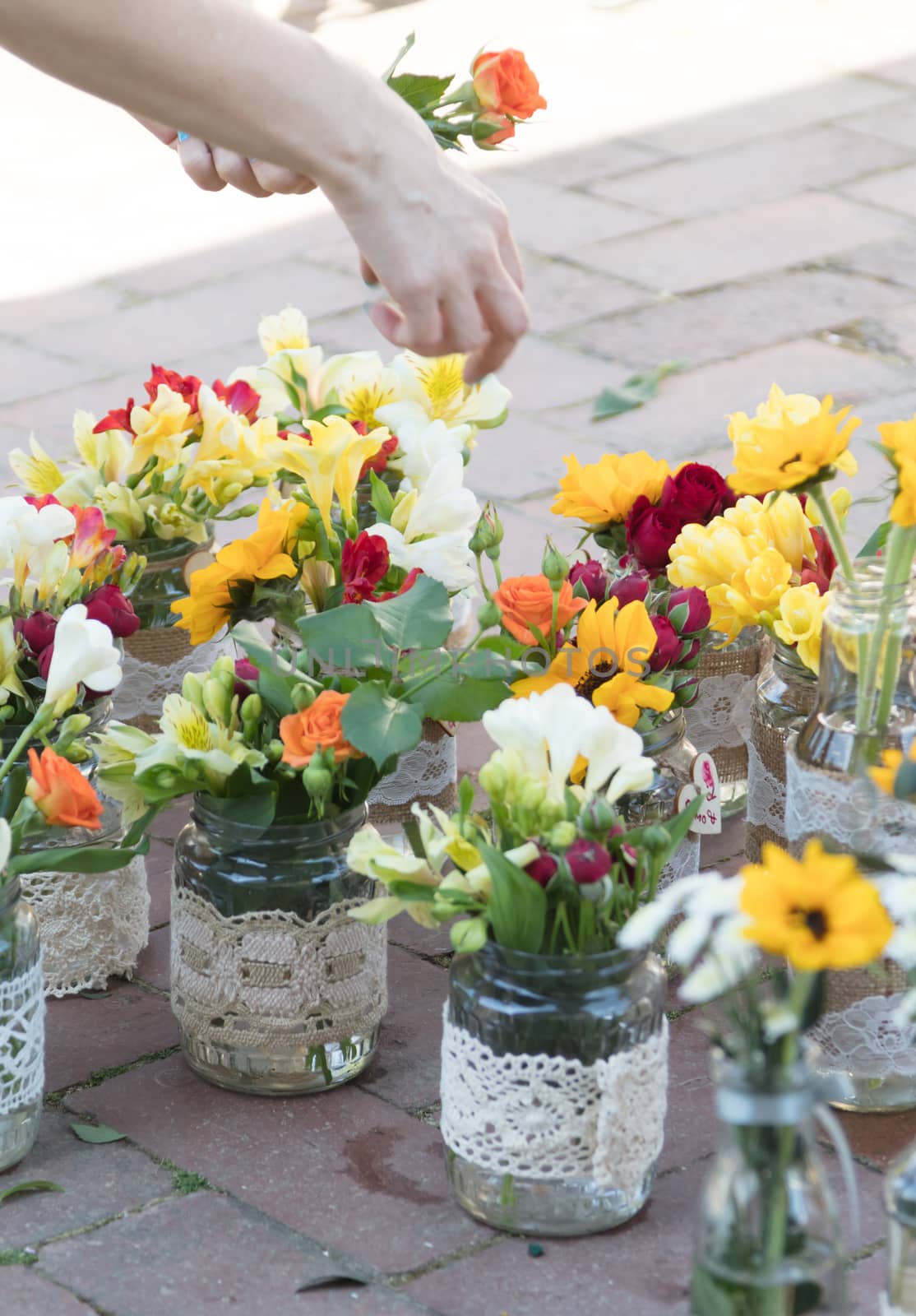 Making small flower bouquets for a wedding, Romania