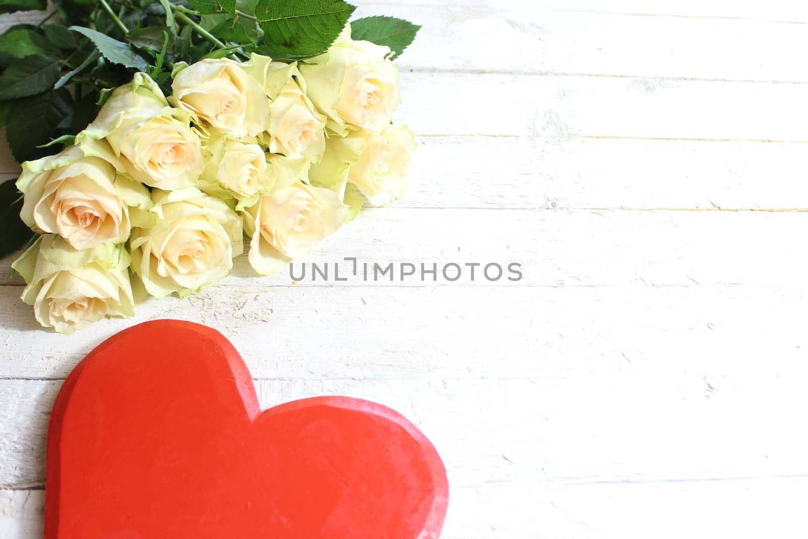 The picture shows white roses and a red heart.