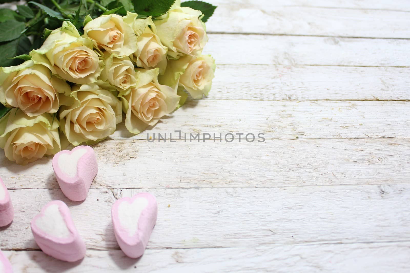 The picture shows white roses and marshmallow.