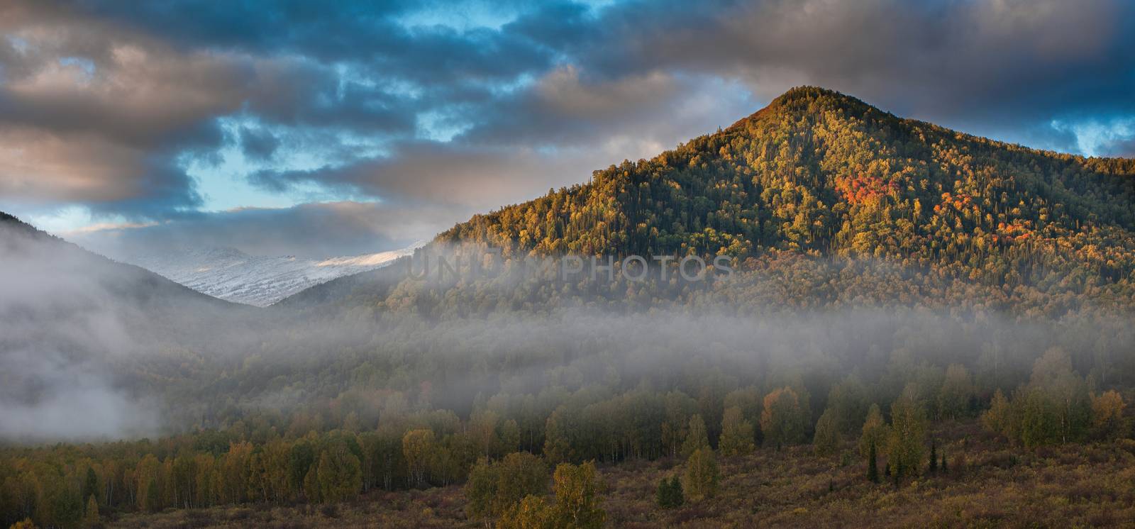 Panoramic picture of sunrise in Altai mountains nature reserve. The beginning of autumn, September