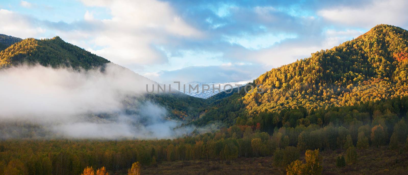 Panoramic picture of sunrise in Altai mountains nature reserve. The beginning of autumn, September