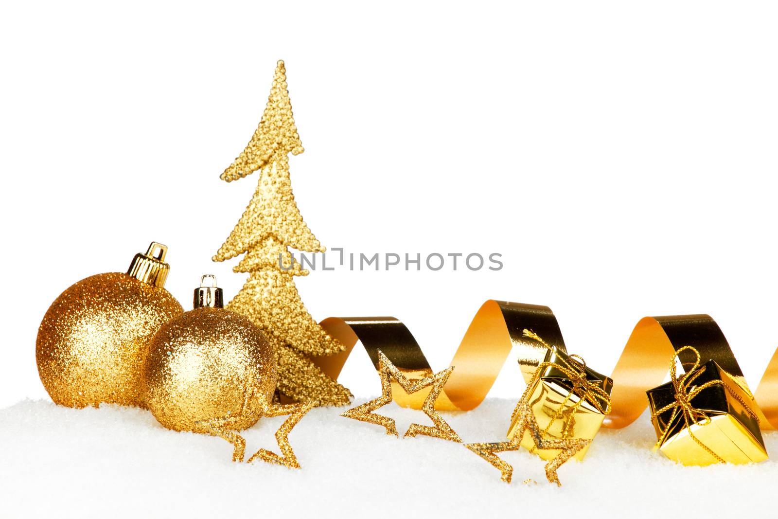 Golden Christmas decorations on snow close-up