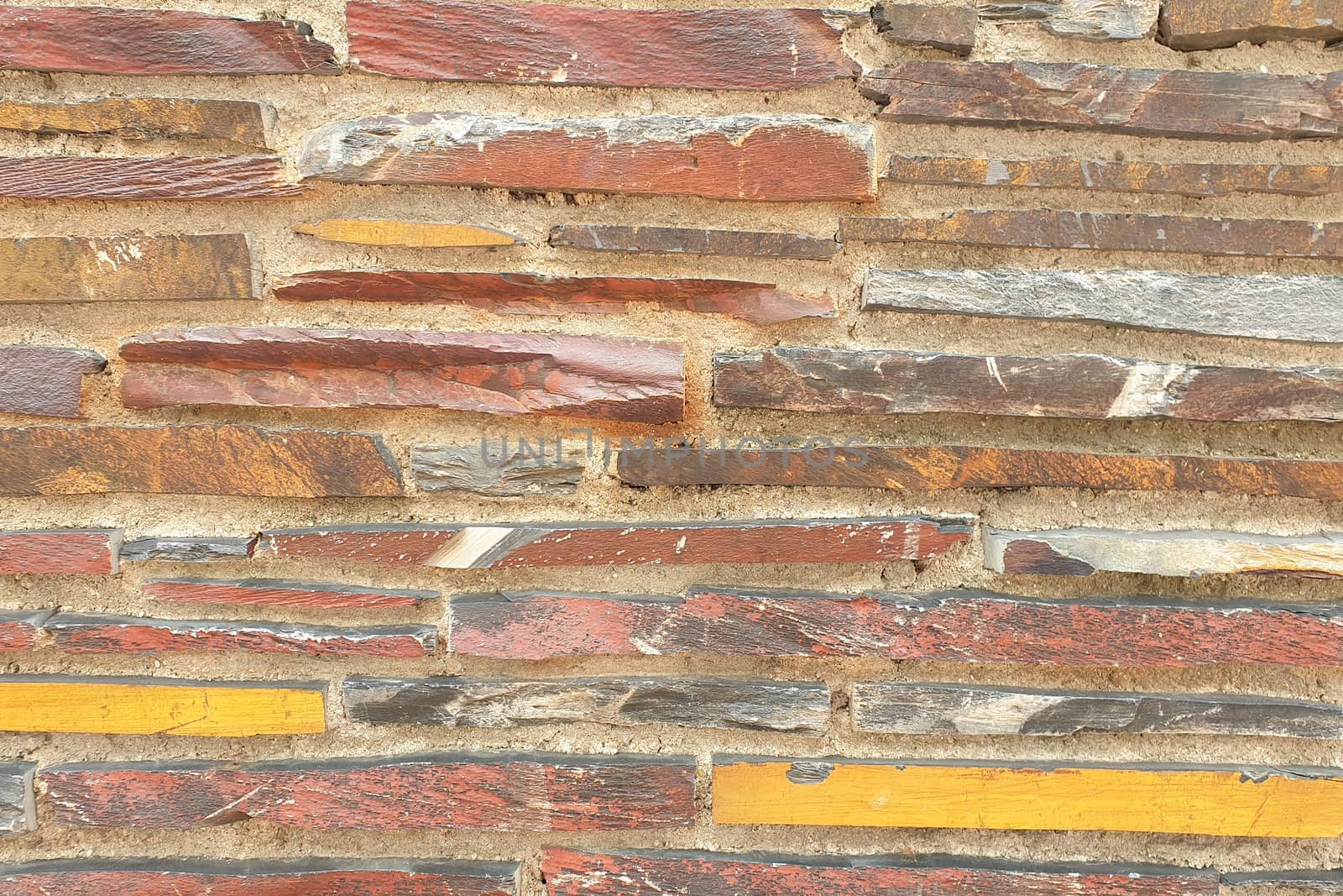 A stone wall of raw stone. Texture of stone.