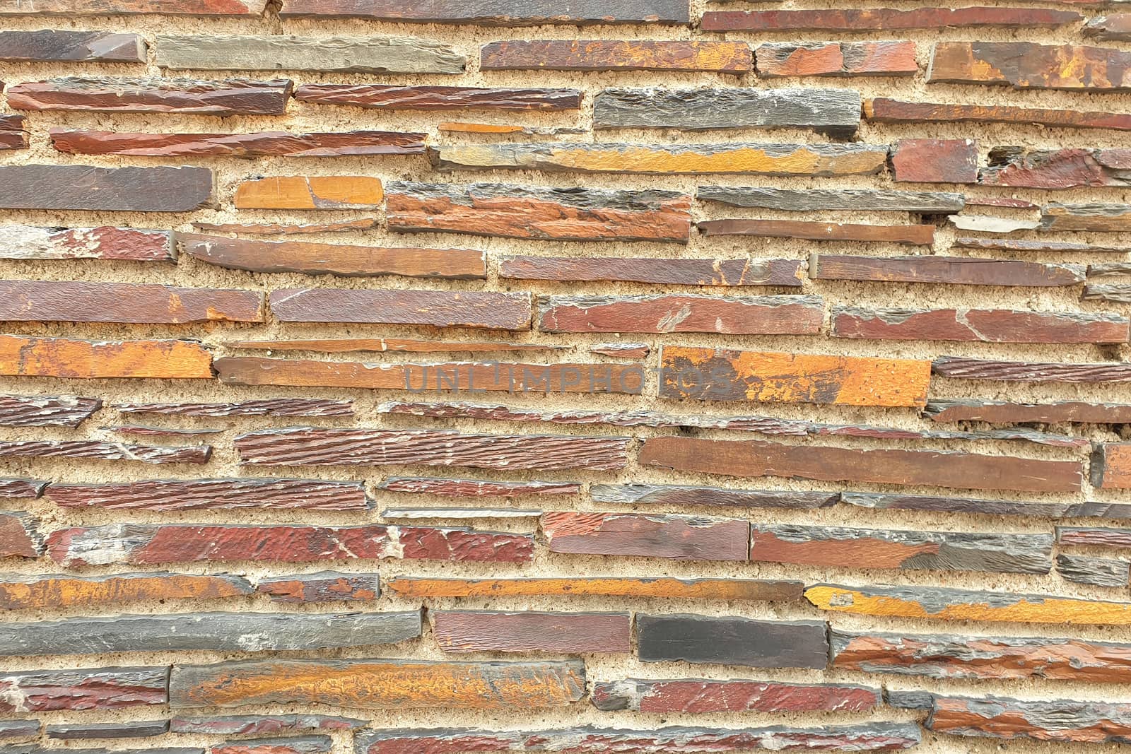 A stone wall of raw stone. Texture of stone.