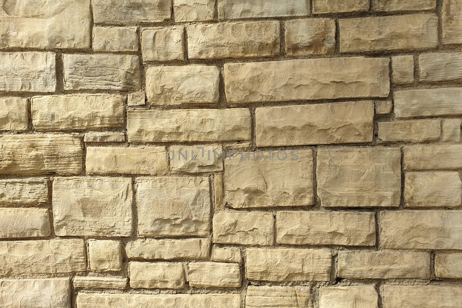 A stone wall of raw stone. Texture of stone.