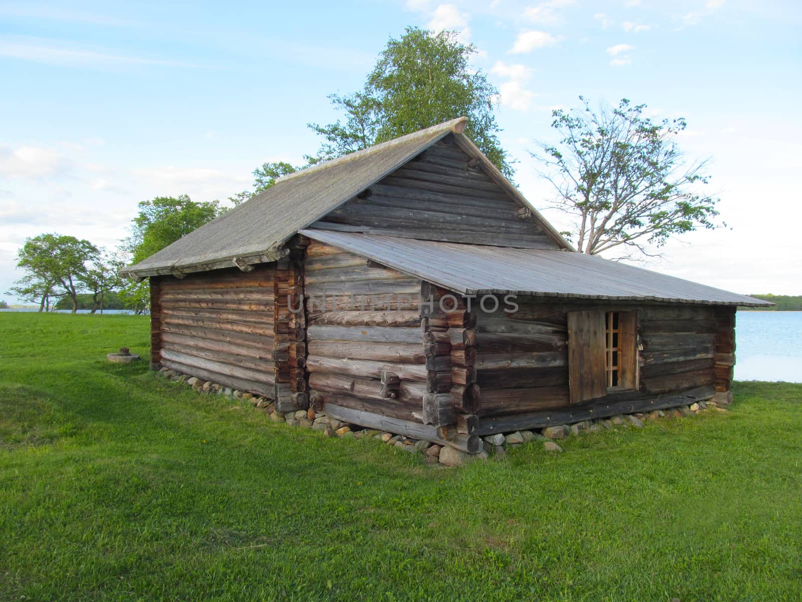 
The village barn is made of pine logs with a gable roof. by Igor2006