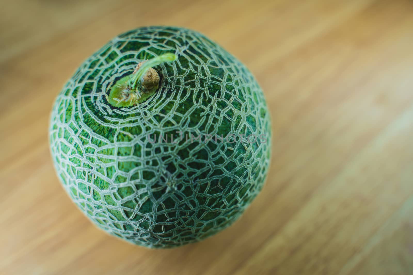 Green melon on wooden. Still life green melon on wooden background