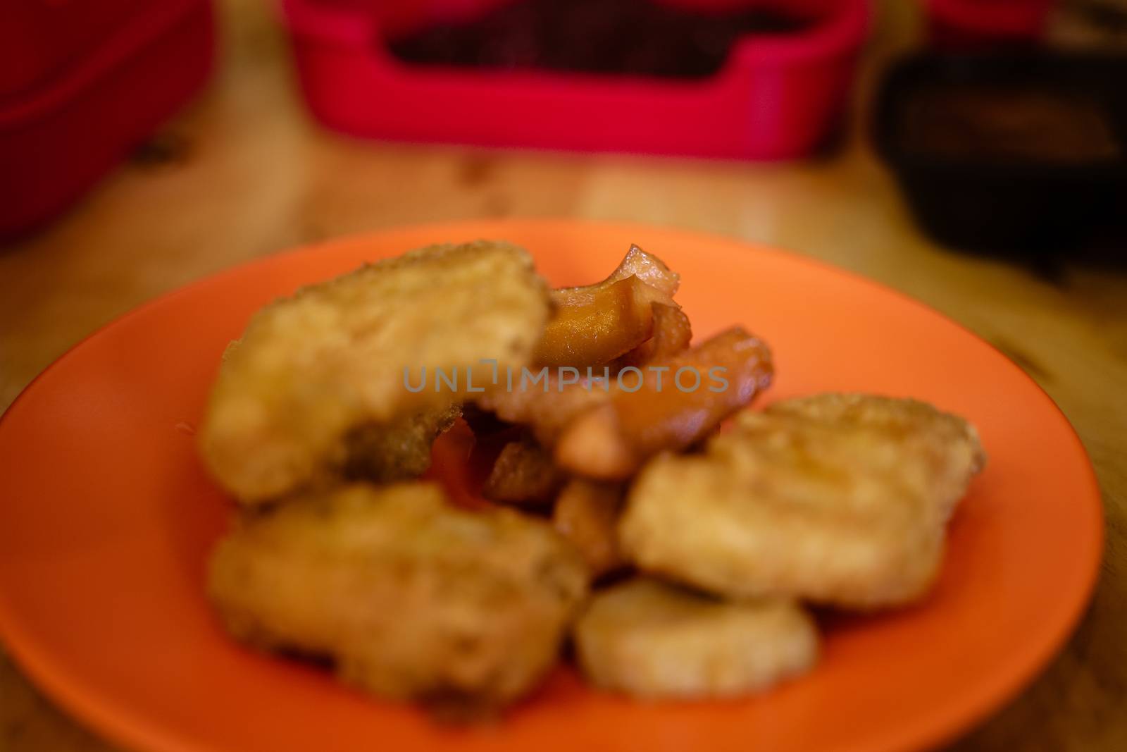 The Homemade Crispy Popcorn Chicken on orange plate