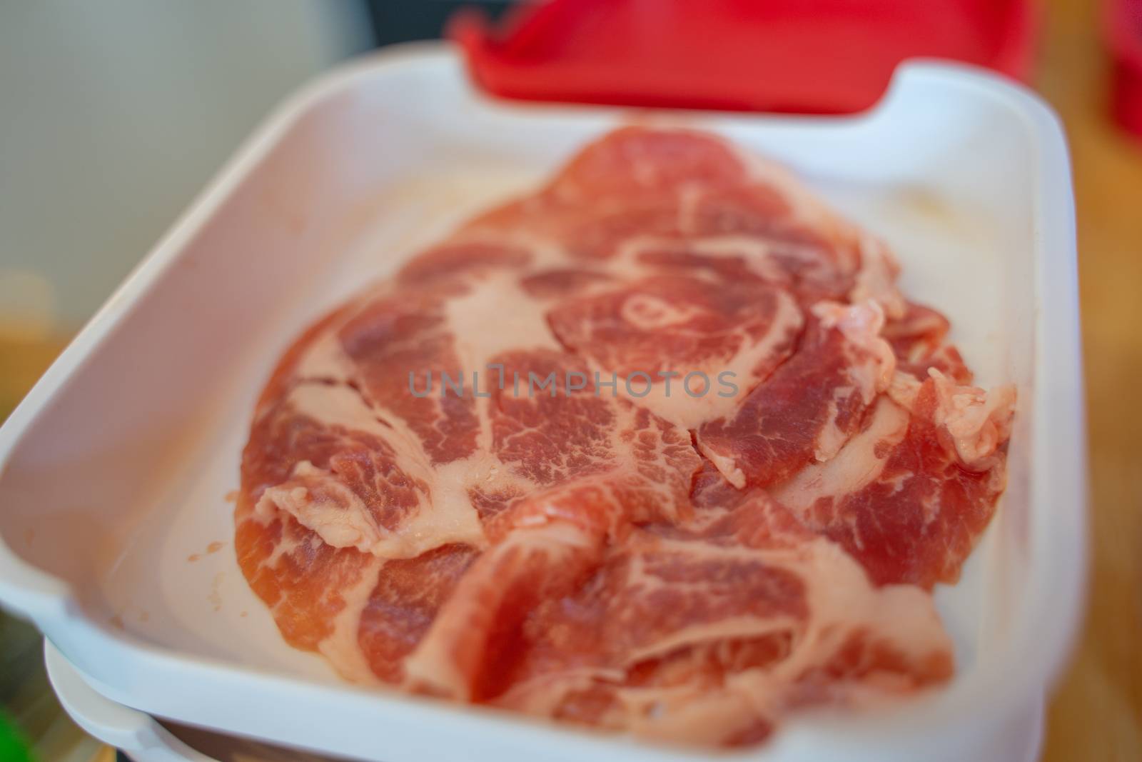 The Thin sliced pork boston butt in plastic tray