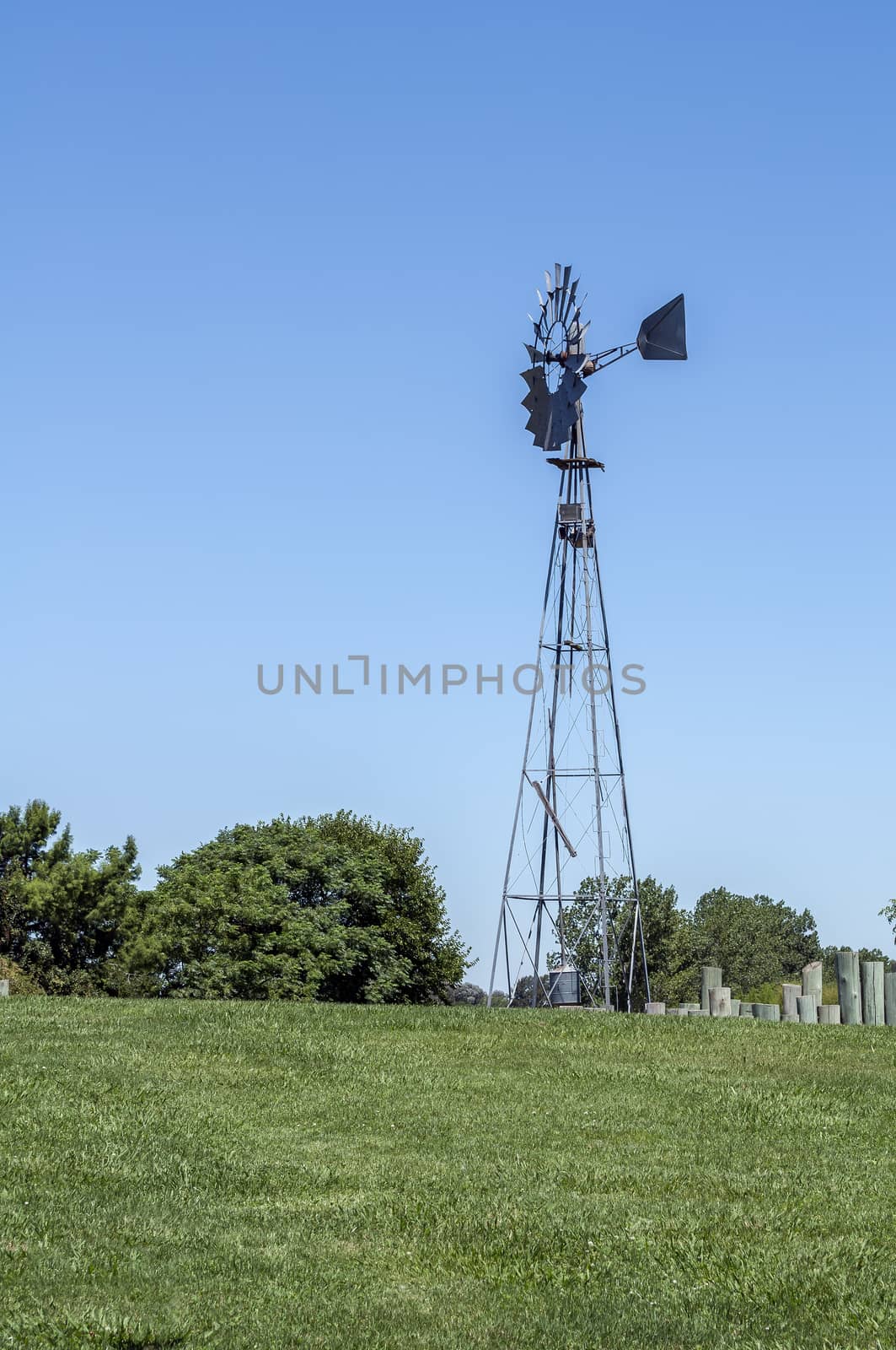 Wind mill supplies water to rural farm.