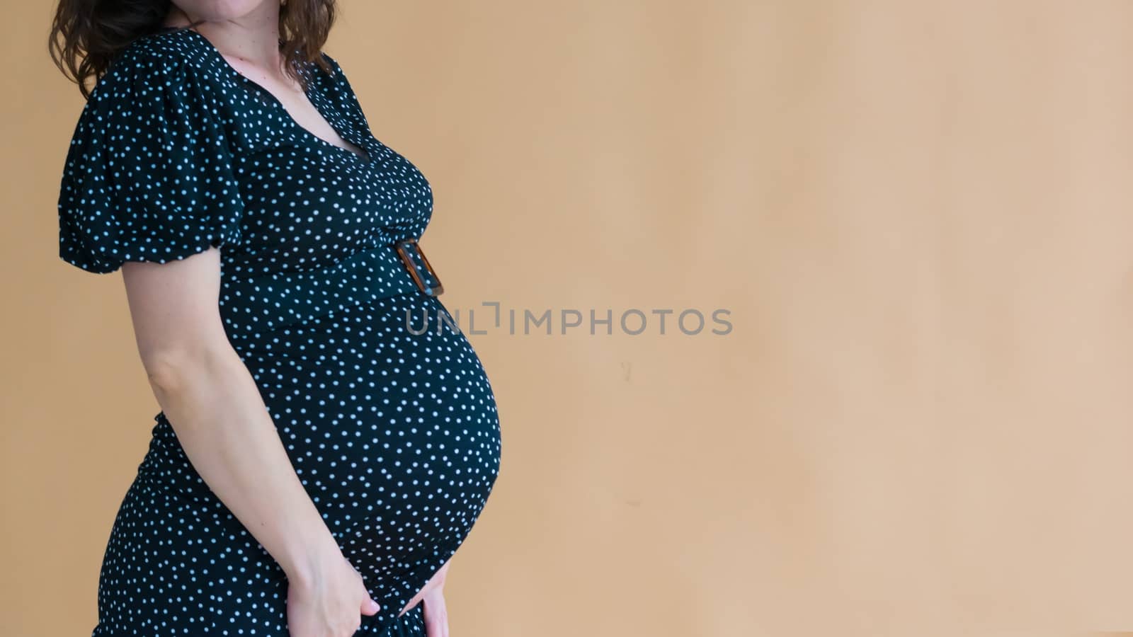 pregnant young woman in dark dress