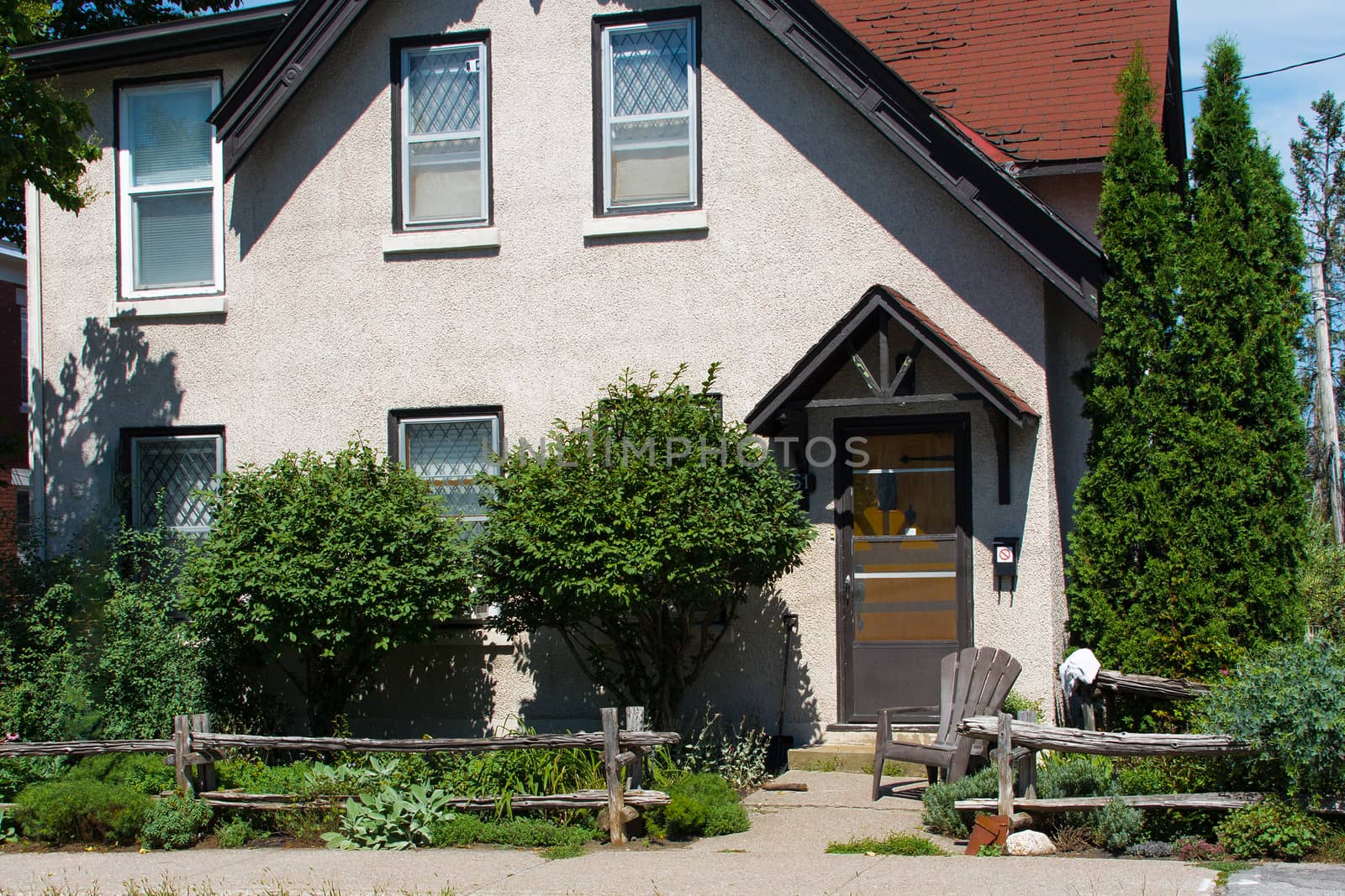 Fragment of an old house with an armchair at the entrance and an icon prohibiting entry