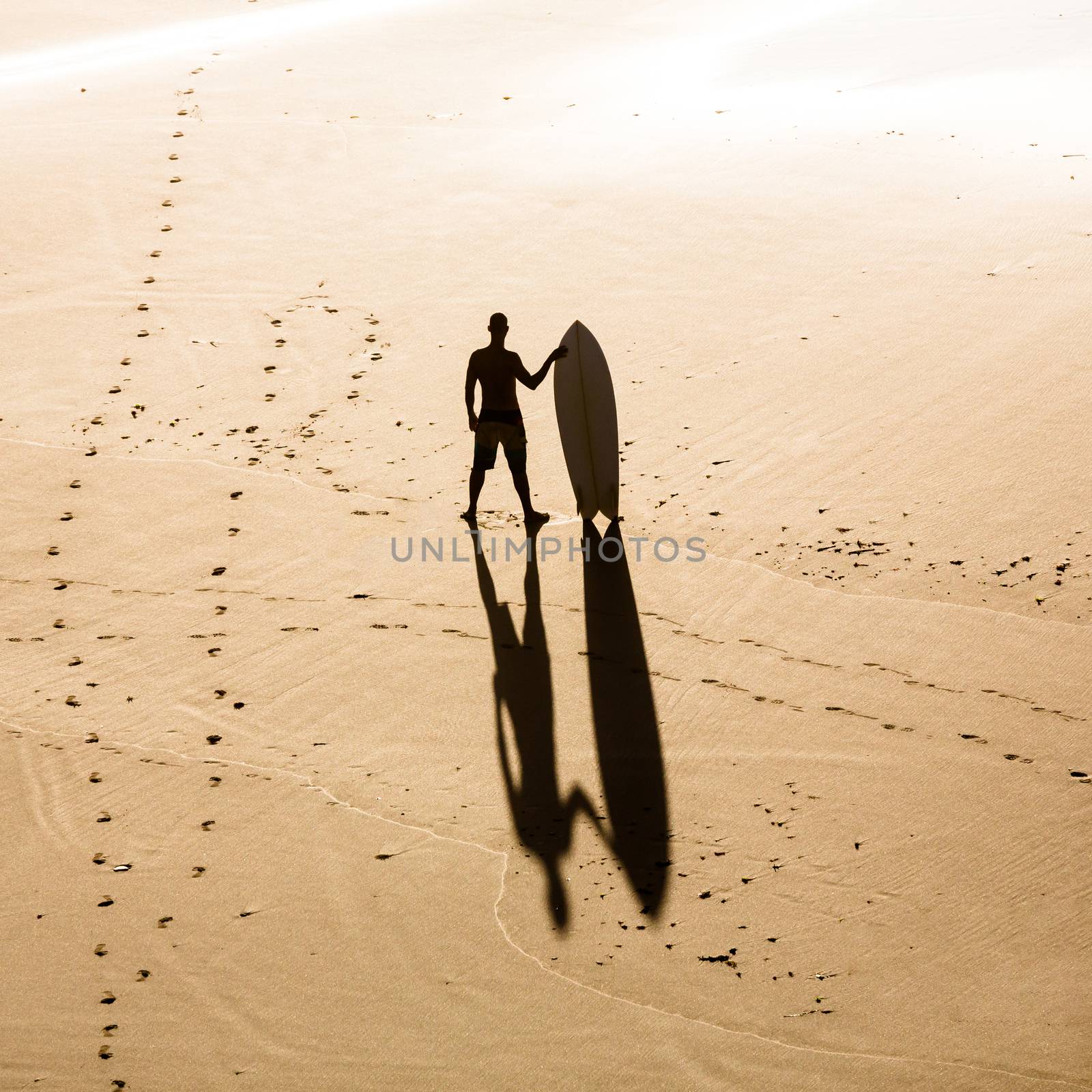 Top view of a surfer on the beach