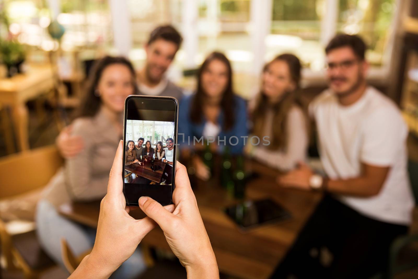 Taking a photo of a group of friends at the bar 
