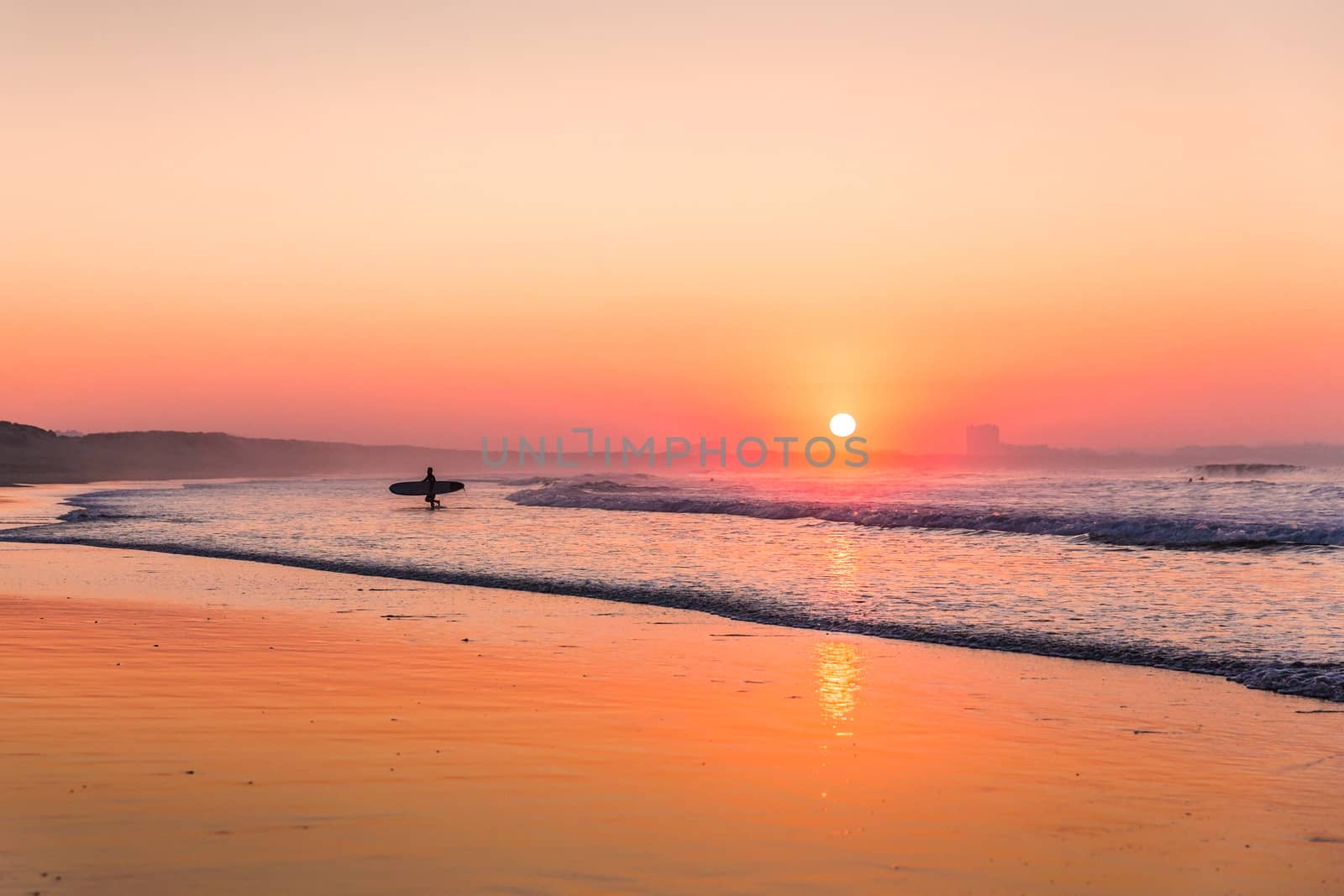 Surfer leaving the ocean after a long day of surf(