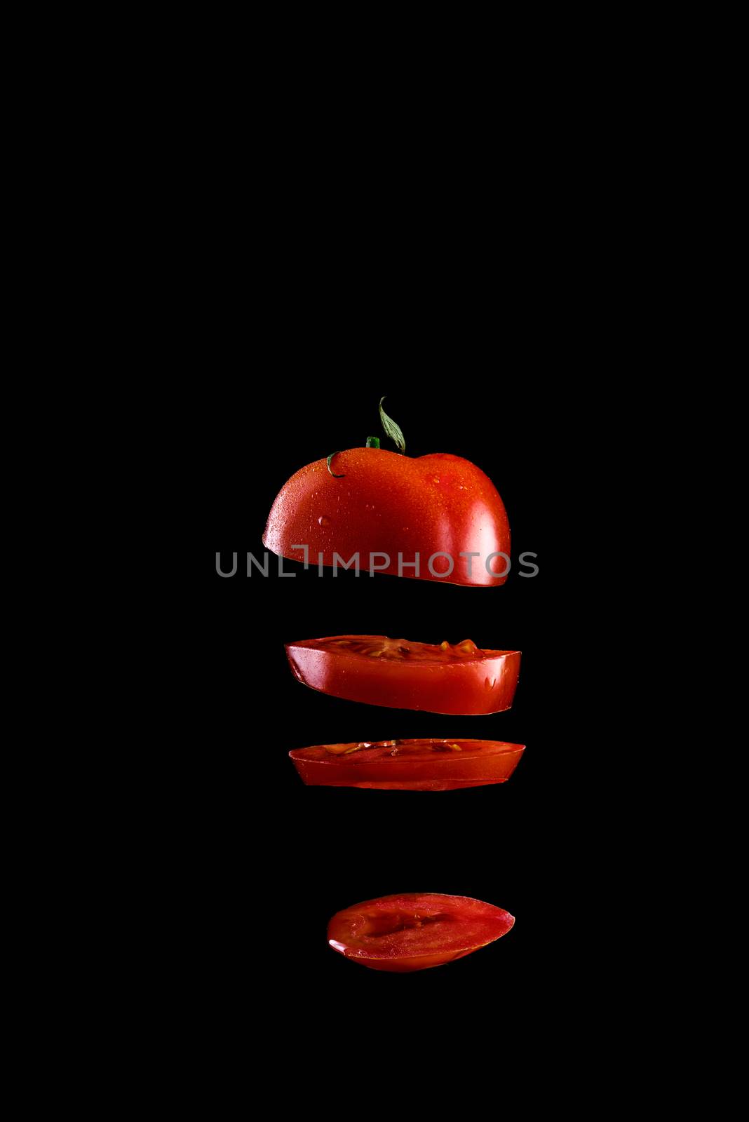 5 Flying tomato slices on a black background by dmitry_derenyuk